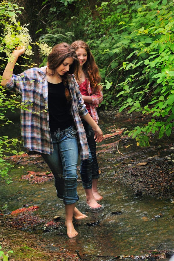 https://thumbs.dreamstime.com/b/wet-fun-two-pretty-young-country-girls-walking-creek-bed-bare-feet-exploring-woods-both-long-hair-49284258.jpg