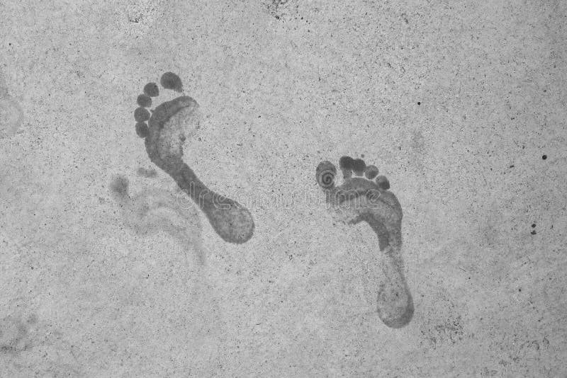 Wet male footprints on concrete surface royalty free stock photos