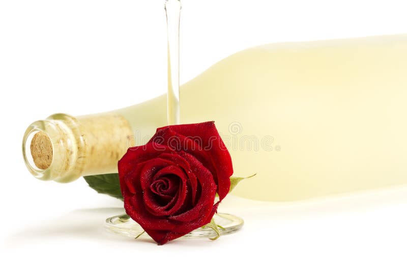 Wet red rose with a empty champagne glass in front