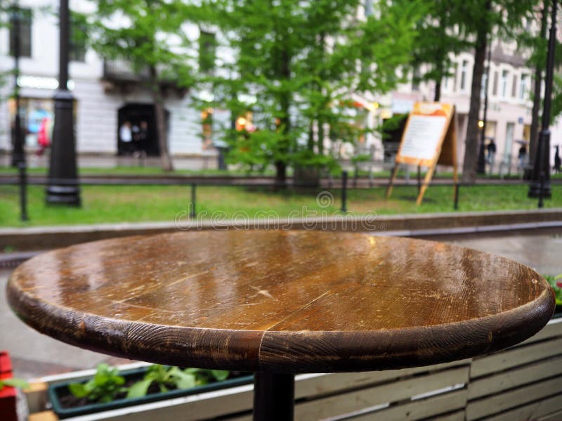 Wet round wooden table with drops of rain stock image Wet round wooden table with drops of rain stock image