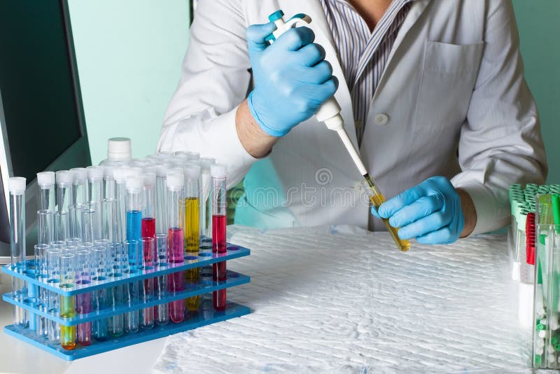 Wetenschapper pipetteert monster voor onderzoek in buis royalty-vrije stock afbeeldingen