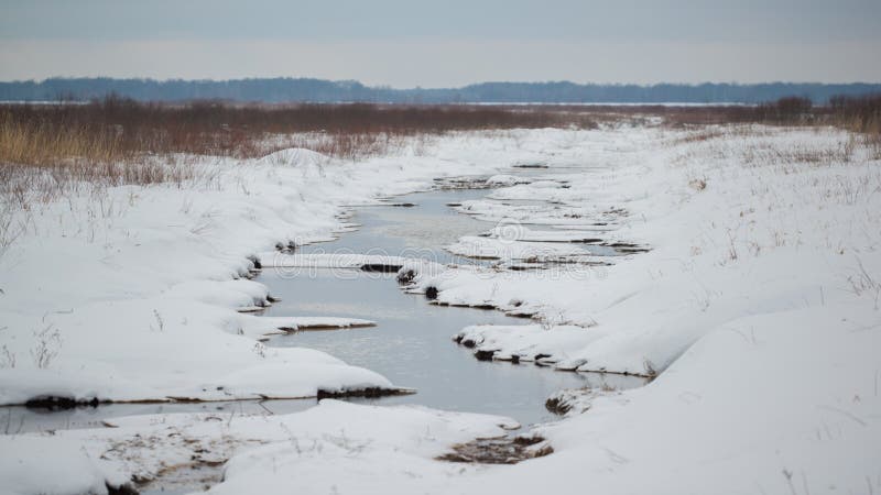 Wetland creek vanishing into the grasslands - on a snowy cold winter overcast day in the Crex Meadows Wildlife Area in Northern Wi royalty free stock image Wetland creek vanishing into the grasslands - on a snowy cold winter overcast day in the Crex Meadows Wildlife Area in Northern Wi royalty free stock image