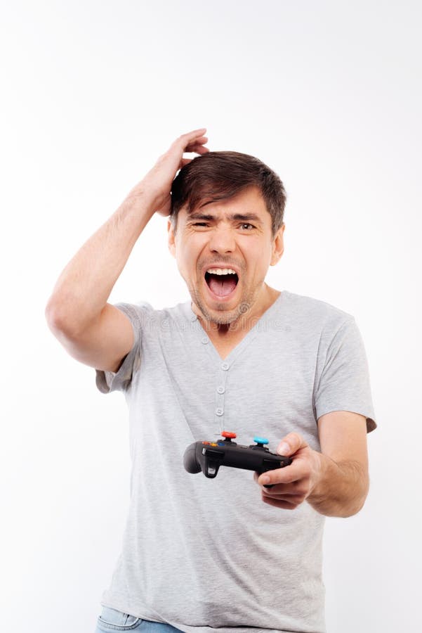 Frustrated Long Haired Gamer Clutching Video Game Controller Stock