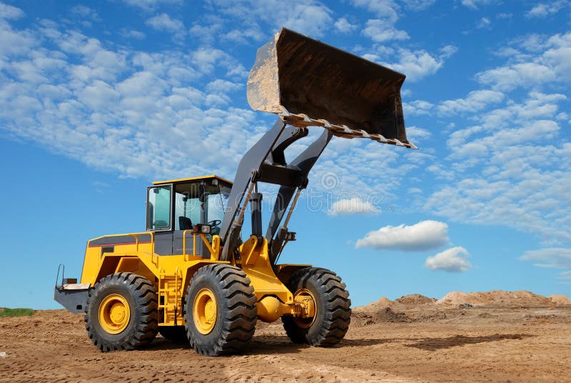 Wheel loader bulldozer in sandpit stock photos