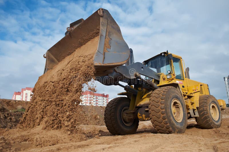 Wheel loader at eathmoving works stock photos