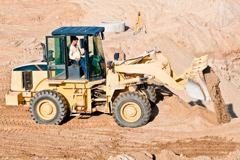 Wheel loader excavator unloading sand royalty free stock photography