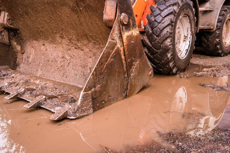 Wheel loader in the mud stock photo. Image of dirt, wheel 193595922