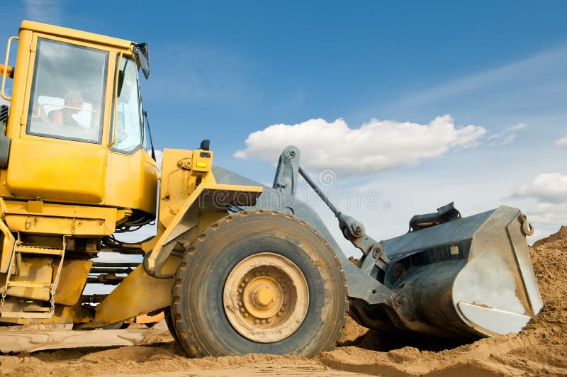 Wheel loader over blue sky stock photography