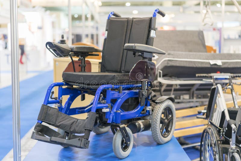 Wheelchair at a medical exhibition. Wheelchair with electric motor. royalty free stock photography