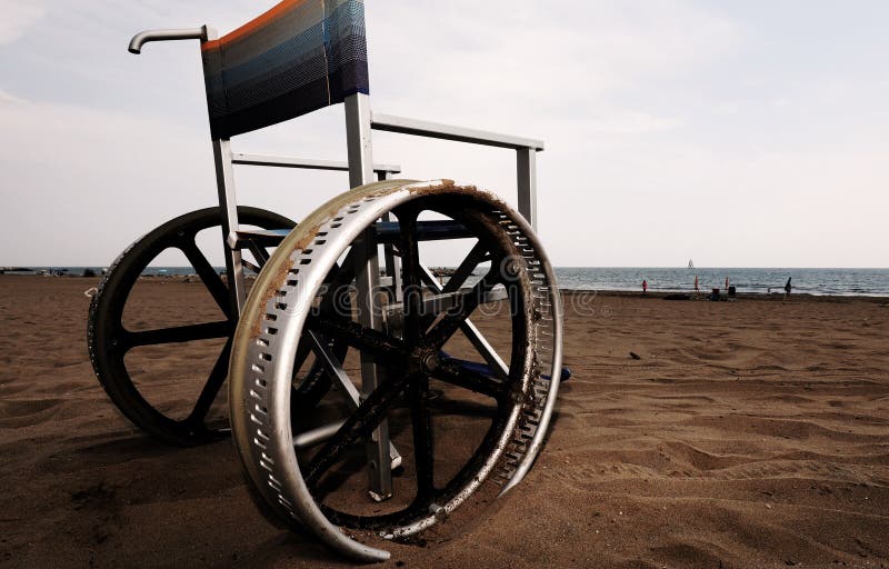 Wheelchair with Wheel on the Beach with Dark Toned Effect Stock Image