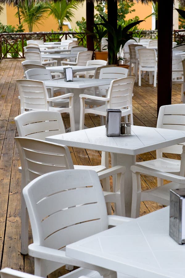 Whie plastic chairs and tables on the patio