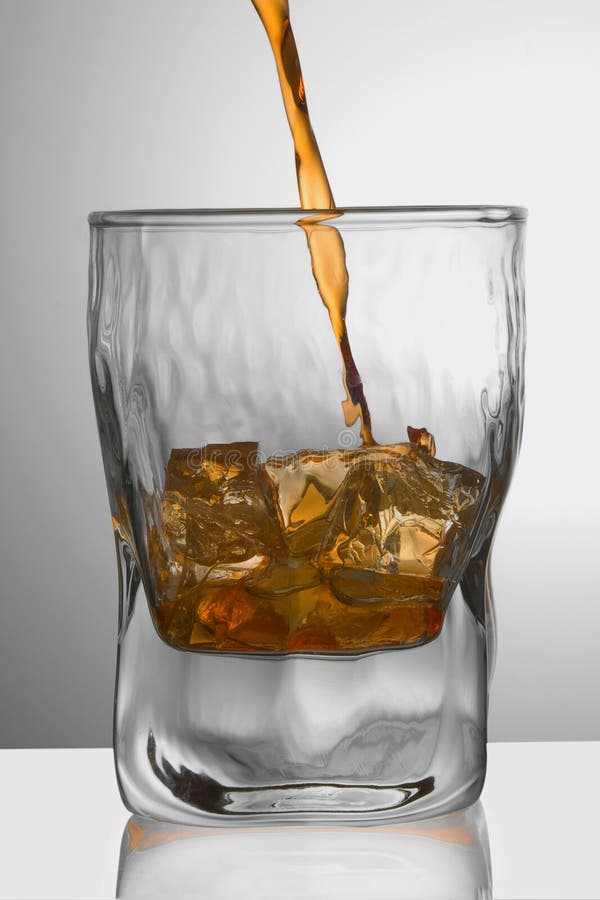 Whiskey/Cognac Being Poured into a Glass Stock Photo Image of liquid