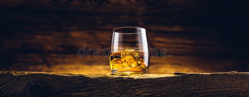 Whiskey glass on the old table