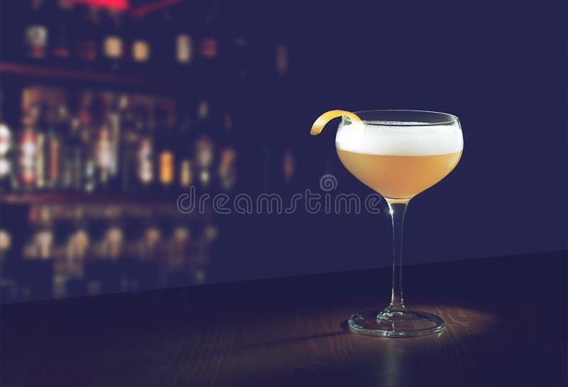 Whiskey Sour Cocktail - Bourbon with Lemon Juice, Sugar Syrup and Egg White in a special glass with copy space