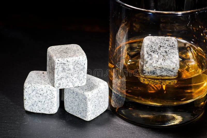 Whiskey with Whiskey Stones. a Glass of Whiskey in a Crystal Glass with