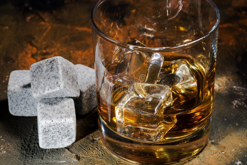 Whiskey with Whiskey Stones. Glass of Whiskey in Glass Cup with Ice