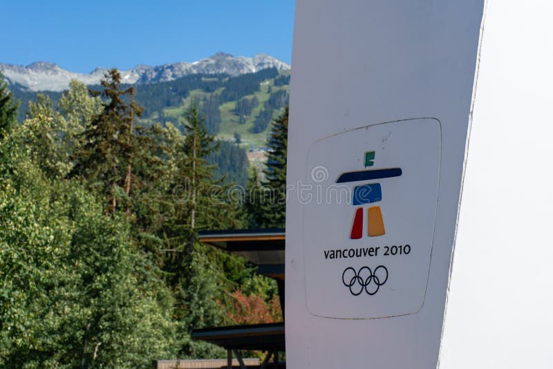 `Whistler, British Columbia/Canada - 08/07/2019: Whistler village Vancouver 2010 Olympics sign looking towards the Whistler Mountain and Blackcomb ski resort and logo for games the inukshuk