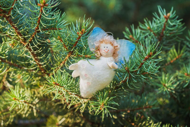 White Angel, handmade, on a green spruce Christmas decorations stock images White Angel, handmade, on a green spruce Christmas decorations stock images
