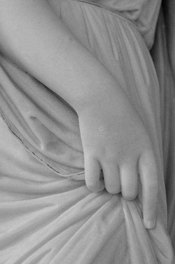 White antique marble stone statue detail of human hand.