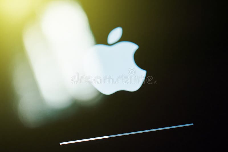 White Apple Computers logo on digital display with update bar