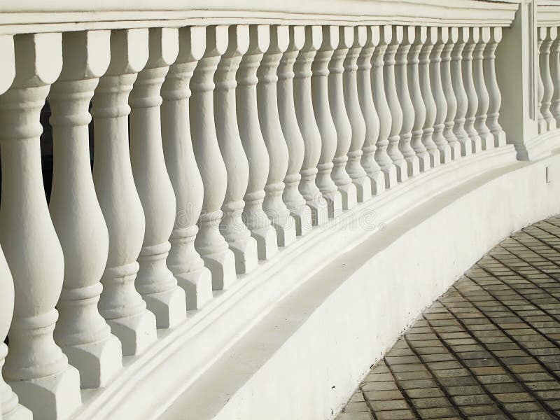 A white painted balustrade with a decorative railing together with its supporting balusters curves around a portion of a tiled driveway. Painted curve stock images, royalty-free photos and pictures