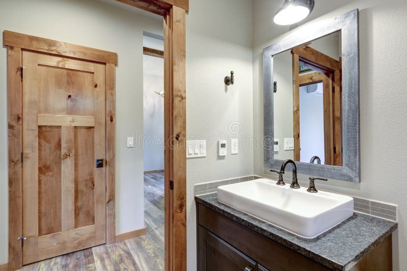 White Bathroom Interior With A Vessel Sink And Gray Counter Top