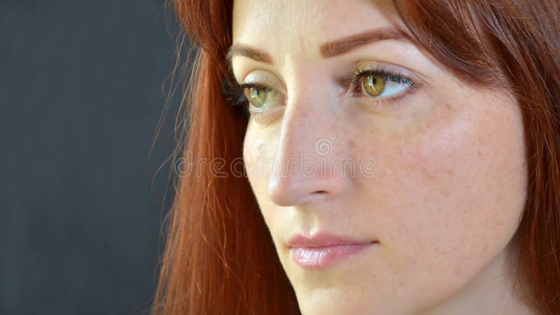White Beautiful Girl with Red Hair and Green Eyes with Eyelash Extensions  on a Dark Background Seriously Looks Right Stock Image - Image of  beautiful, blue: 150821775