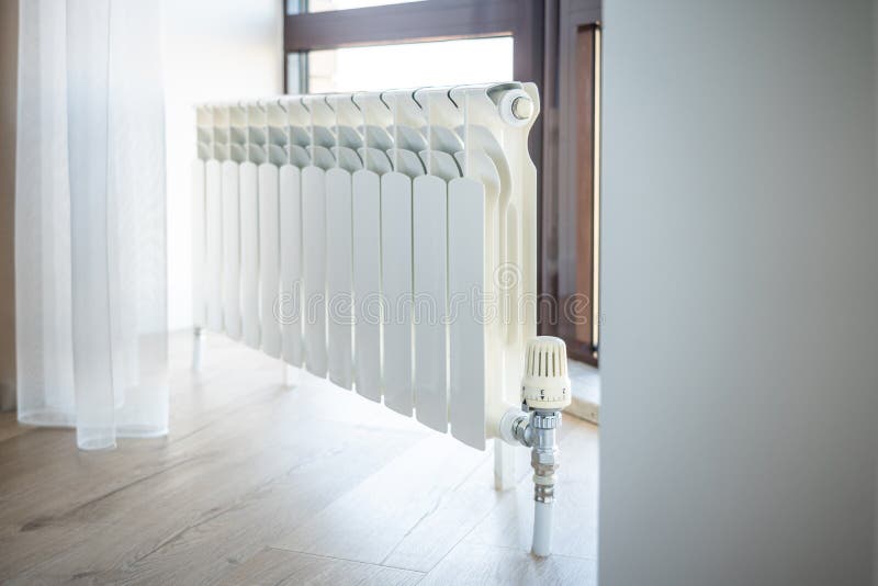 White big radiator with thermostat near window in modern room royalty free stock photos White big radiator with thermostat near window in modern room royalty free stock photos