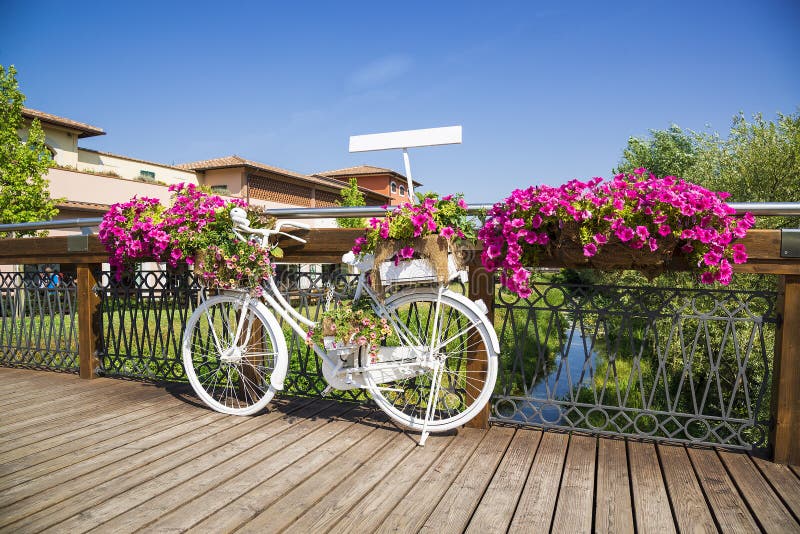 White Bike on wooden bridge with flowers