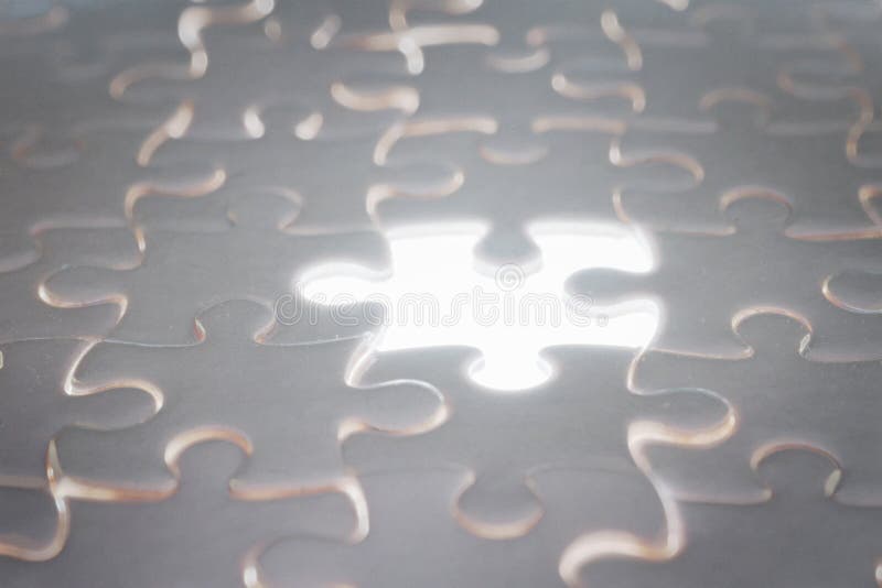 White blank jigsaw puzzle with blank illuminated piece royalty free stock image