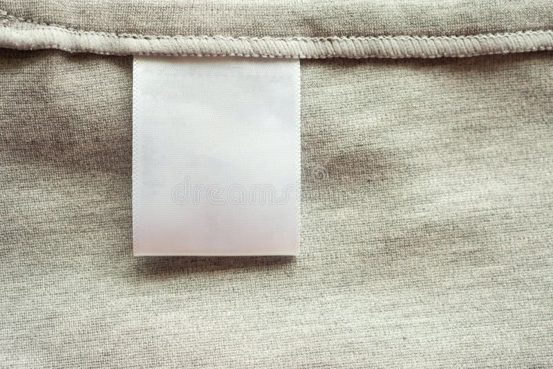 White Blank Laundry Care Clothing Label on Fabric Texture Background ...