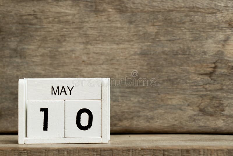 White block calendar present date 10 and month May on wood background stock images White block calendar present date 10 and month May on wood background stock images