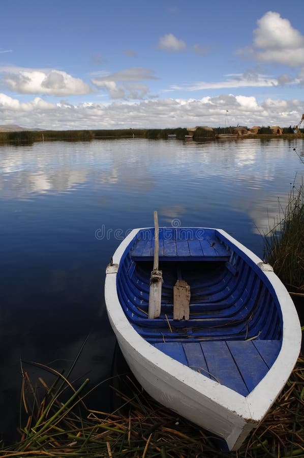 White blue boat onshore reef floating island stock photo