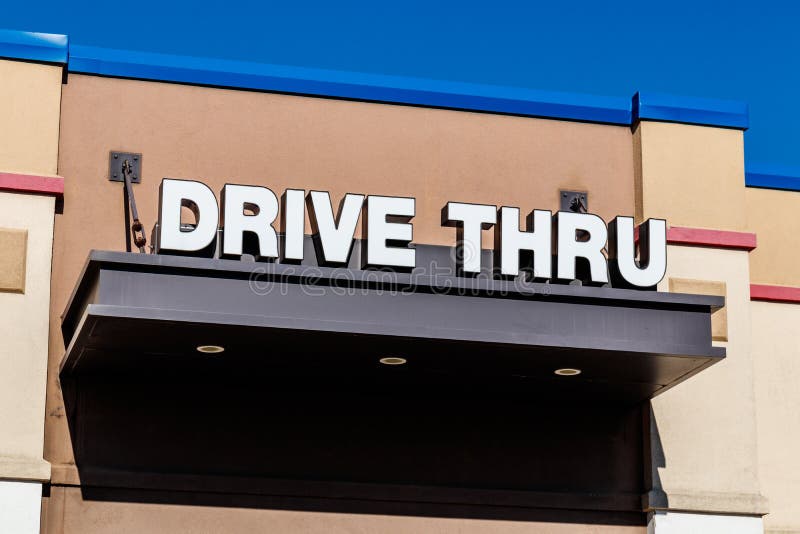 White and Blue Drive Thru sign set against a blue sky II