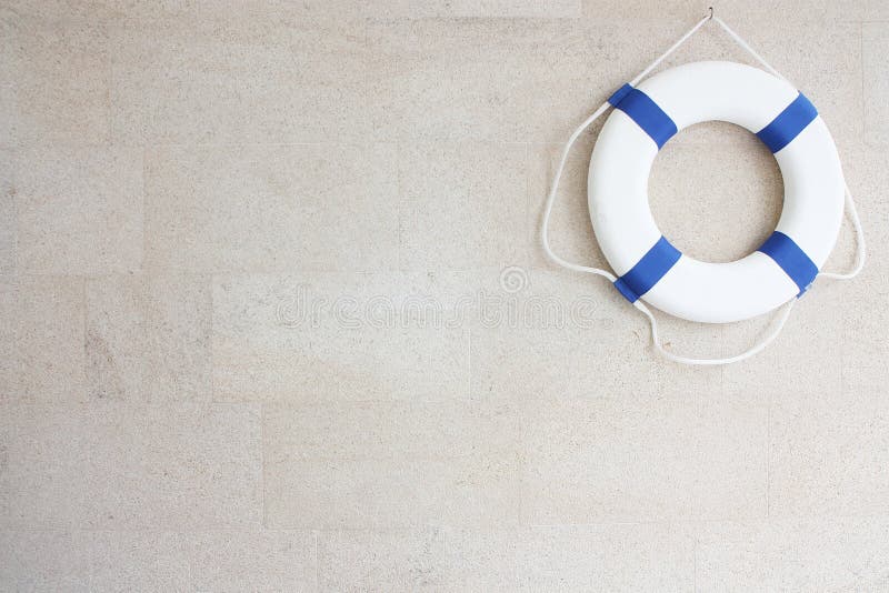 White and blue lifebuoy on wall