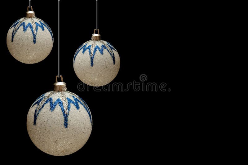 White-blue shiny Christmas balls on a black back