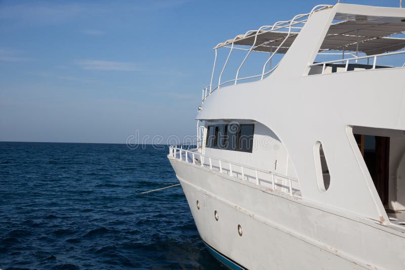 The white boat floats by sea royalty free stock photos