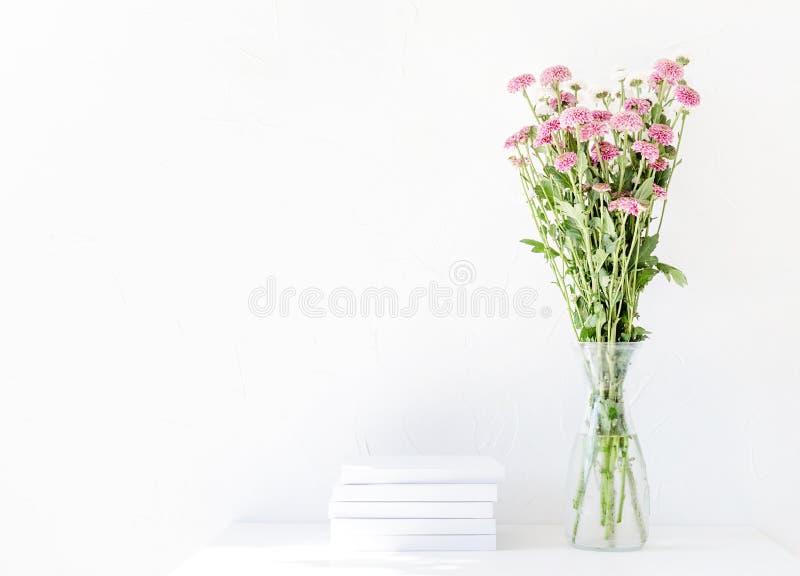 White Book Mockup with Chrysanthemum Flowers in a Vase on a White Table