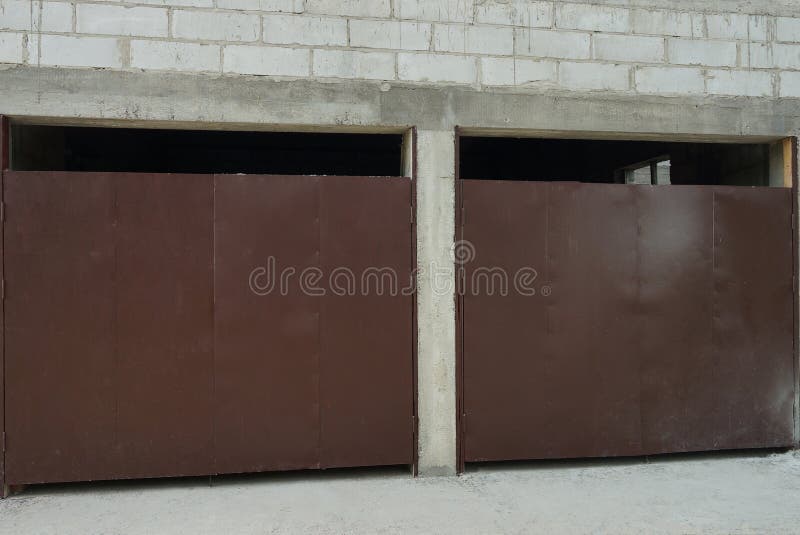 White Brick Garage Facade with Two Brown Iron Gates Stock Photo Image