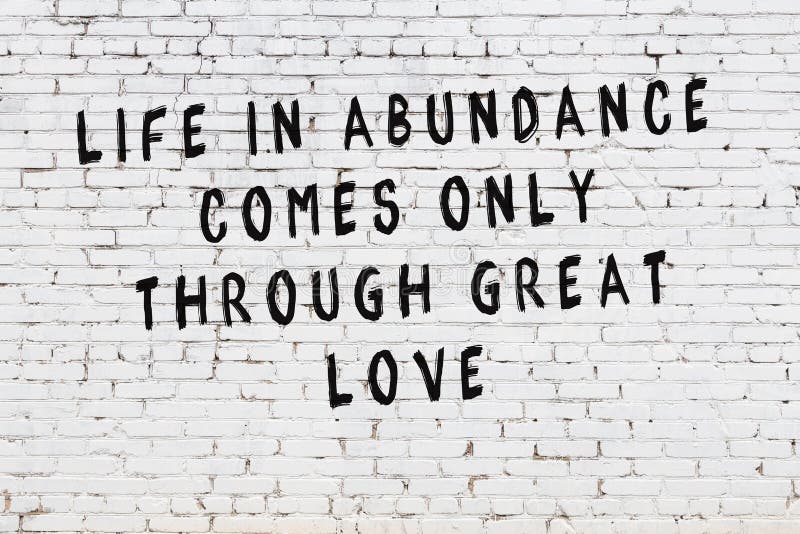 White Brick Wall with Painted Black Motivational Quote Inscription