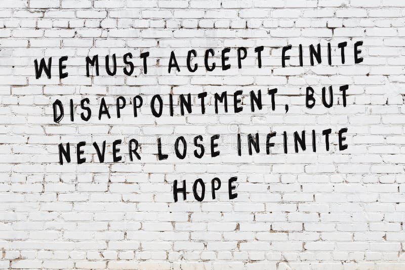 White Brick Wall with Painted Black Motivational Quote Inscription