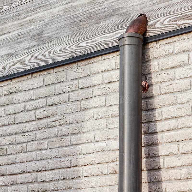 White Brick Wall with Wooden Frontal Board and Copper Pipe during