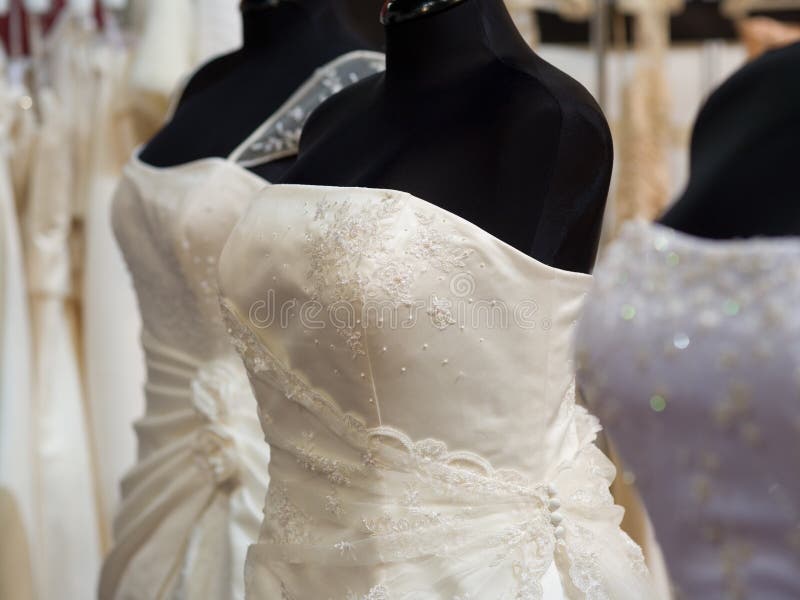 White bride costumes on shop mannequins