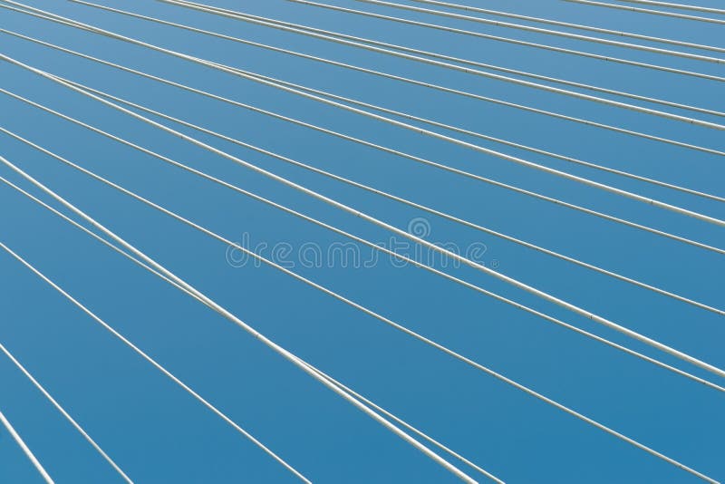 White bridge cable stays in diagonal pattern across blue background. From Veterans Memorial Bridge across Mississippi River in St