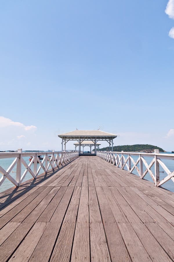 White bridge in to the sea with blue sky vertical