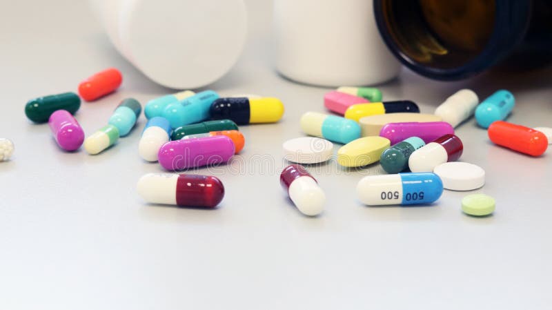 White and Brown glass medicine bottles with colorful tablets, pills, capsules drugs using for treatment and cure the disease. White and Brown glass medicine stock photos White and Brown glass medicine bottles with colorful tablets, pills, capsules drugs using for treatment and cure the disease. White and Brown glass medicine stock photos