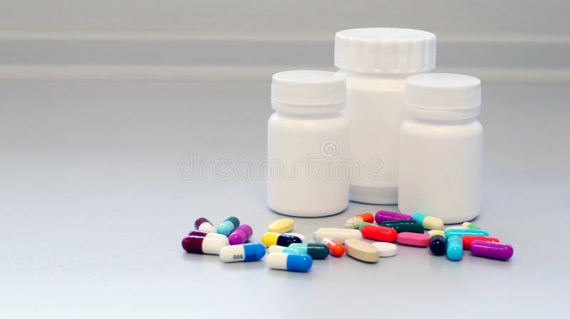 White and Brown glass medicine bottles with colorful tablets, pills, capsules drugs using for treatment and cure the disease. White and Brown glass medicine stock image White and Brown glass medicine bottles with colorful tablets, pills, capsules drugs using for treatment and cure the disease. White and Brown glass medicine stock image