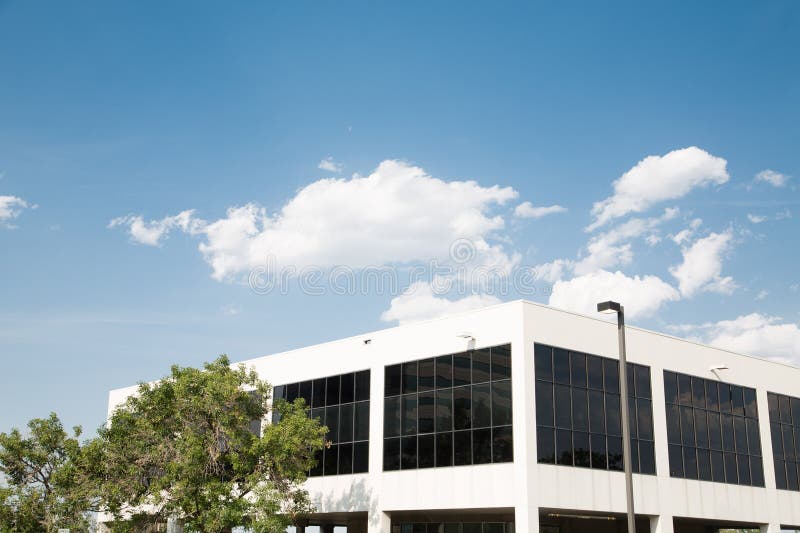 White Building with Black Windows Under Blue Sky