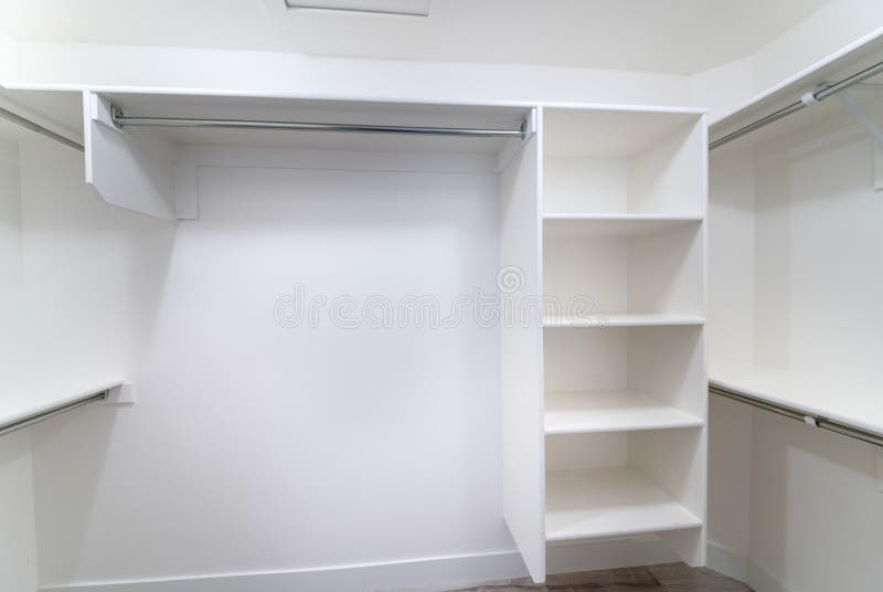 White Builtin Shelving Units Inside a Walkin Closet Stock Image