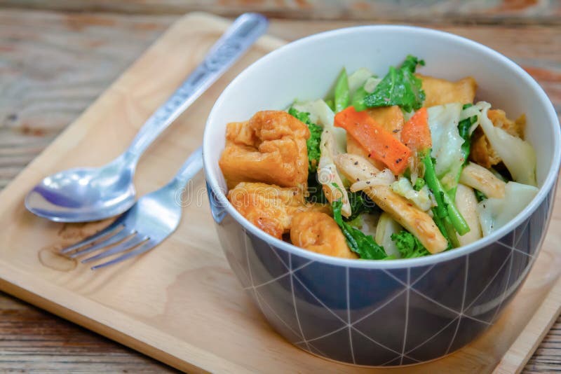 White cabbage, kale, baby corn, mushrooms and fried tofu, and oyster sauce in a bowl of breakfast,mixed vegetable stir-fried